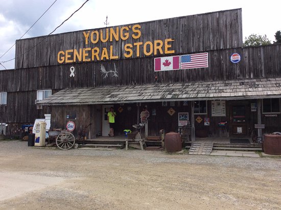 The porch of a classic northern general store with a mounted moose standing guard out front